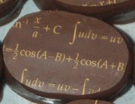 chocolates with mathematical expressions in gold lettering