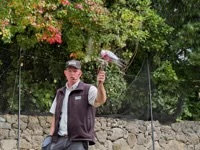 Man holding perch for bird