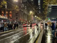 Waiting for a Melbourne tram in the rain